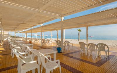 Beachfront terrace with tables and sea view at El Mouradi Port El Kantaoui Beachfront terrace with tables and sea view at El Mouradi Port El Kantaoui
