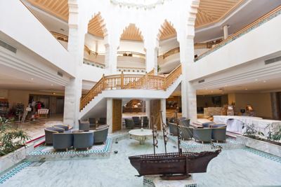 Hotel lobby with grand staircase at El Mouradi Mahdia Hotel lobby with grand staircase at El Mouradi Mahdia