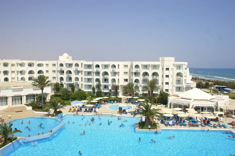 Swimming pool with the hotel and beach behind at El Mouradi Mahdia, Mahdia Swimming pool with the hotel and beach behind at El Mouradi Mahdia, Mahdia