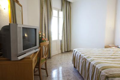 Standard room with striped bedspread at El Mouradi Cap Mahdia Standard room with striped bedspread at El Mouradi Cap Mahdia