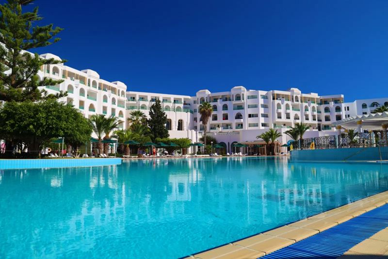 Outdoor swimming pool and hotel building at El Mouradi Hammamet, Yasmine Hammamet Outdoor swimming pool and hotel building at El Mouradi Hammamet, Yasmine Hammamet