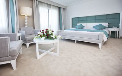 Superior room with double bed and seating area at El Mouradi Hammamet Superior room with double bed and seating area at El Mouradi Hammamet