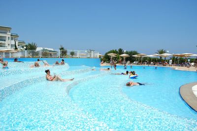 Guests relaxing in the shallow terraced pool at El Mouradi Palm Marina Guests relaxing in the shallow terraced pool at El Mouradi Palm Marina