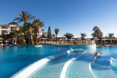 Swimming pool with palm trees at El Mouradi Palm Marina Swimming pool with palm trees at El Mouradi Palm Marina