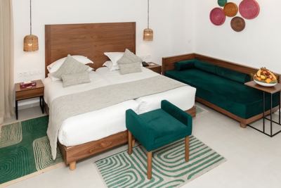 Superior double room with green velvet furniture at El Mouradi Palm Marina Superior double room with green velvet furniture at El Mouradi Palm Marina