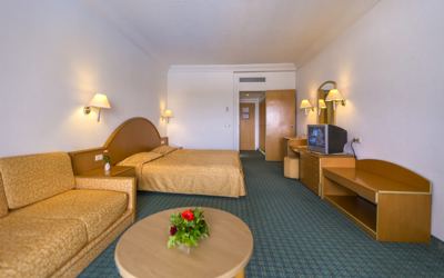 Double room with sofa and seating area at El Mouradi Skanes