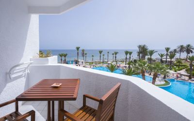 Room balcony with pool and sea view at El Mouradi Skanes